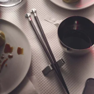 Conjunto de dos palillos de ébano con soporte de inox Alessandro Mendini Alessi